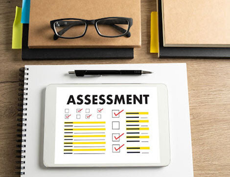 An assessment checklist is shown on a tablet, relating to vet compliance and quality assurance.
