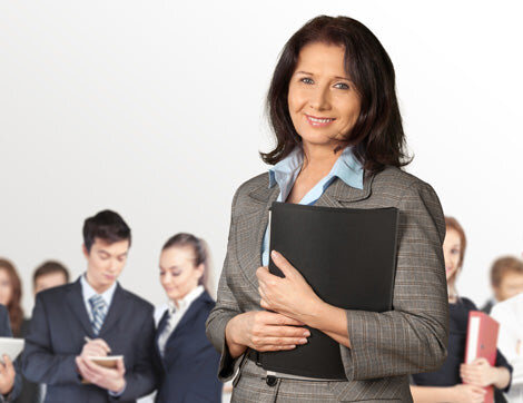 Business Professionals | Career Calling International A businesswoman leads a team of office workers, showcasing Career Calling International's commitment to quality assurance.